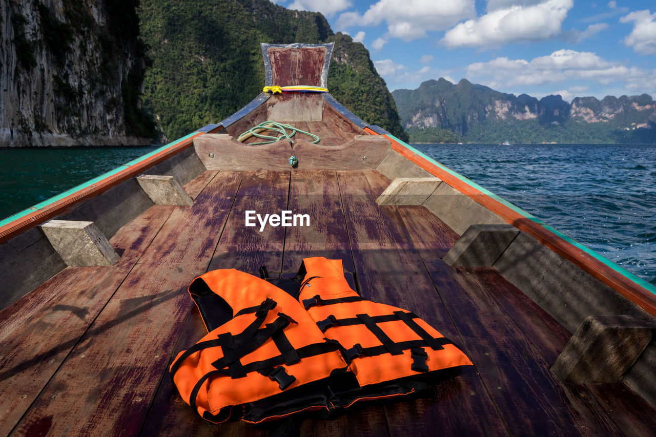 Life jacket with wood prow of a ship going on the sea.