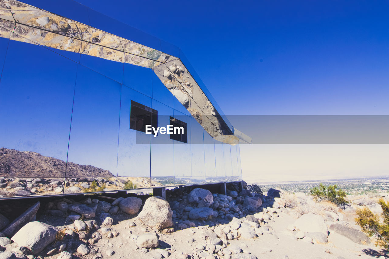 Built structure on beach against clear blue sky