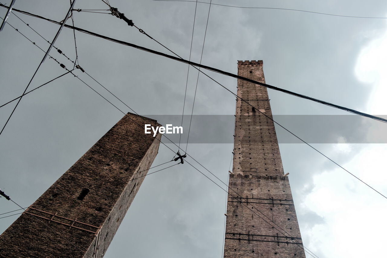 Low angle view of electricity pylon against sky