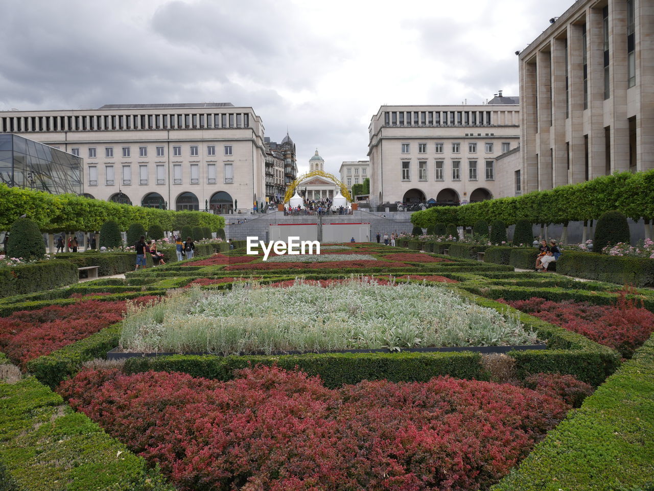 VIEW OF FOUNTAIN IN GARDEN AGAINST BUILDINGS