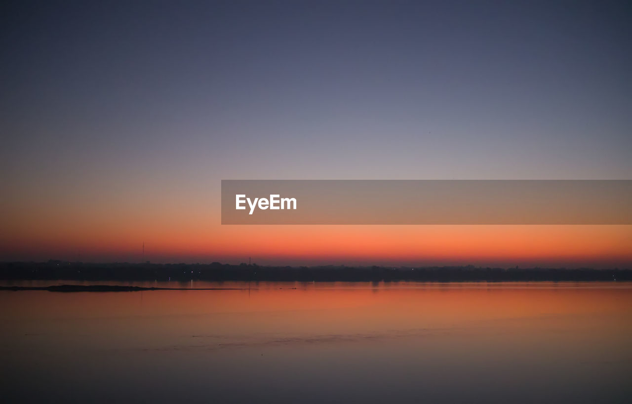 Scenic view of landscape against clear sky during sunset