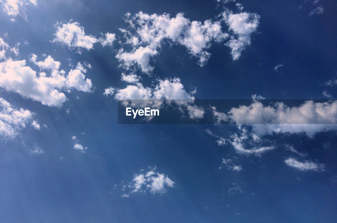 LOW ANGLE VIEW OF CLOUDS IN BLUE SKY