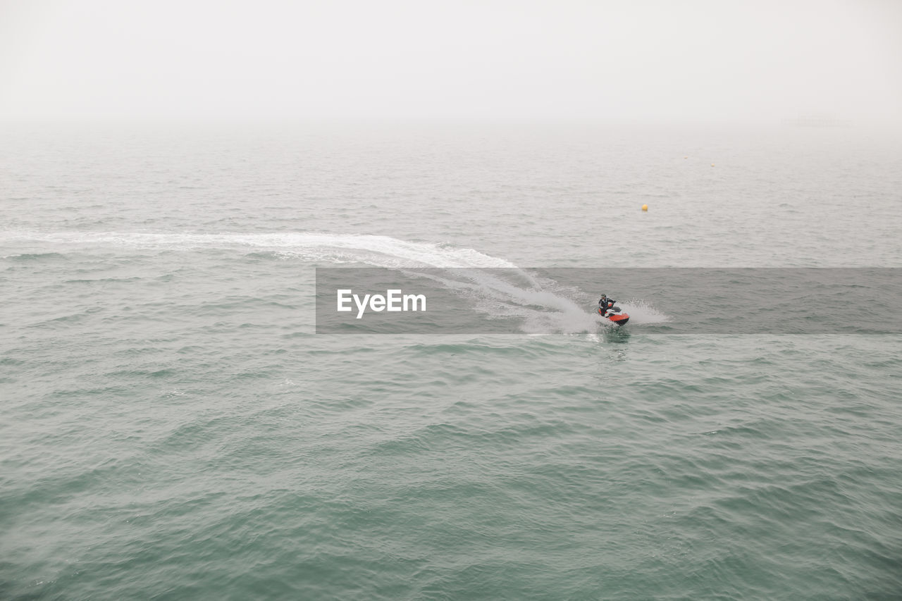 High angle view of man jet boating in sea