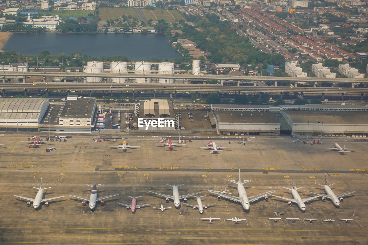 High angle view of airplane flying over city