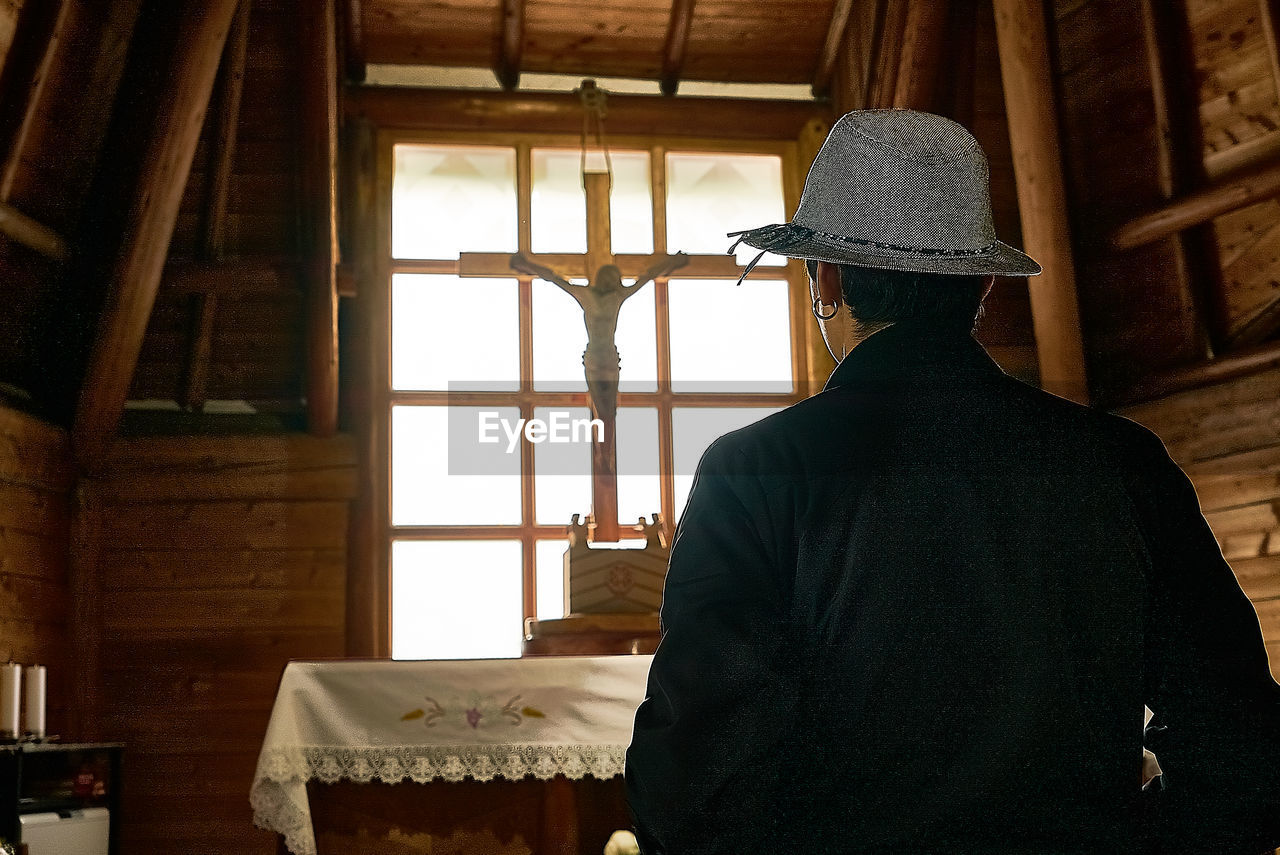 Rear view of man standing in church