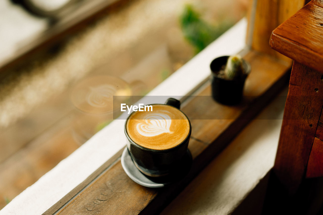 Coffee cup on window sill