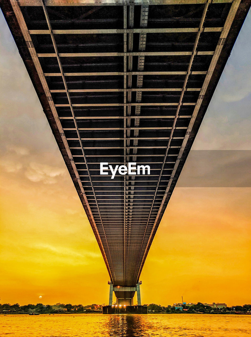 LOW ANGLE VIEW OF BRIDGE AGAINST SKY DURING SUNSET