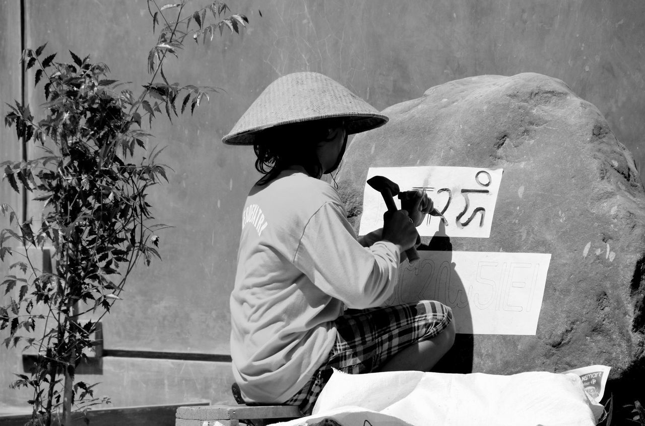 CLOSE-UP OF WOMAN STANDING ON WALL