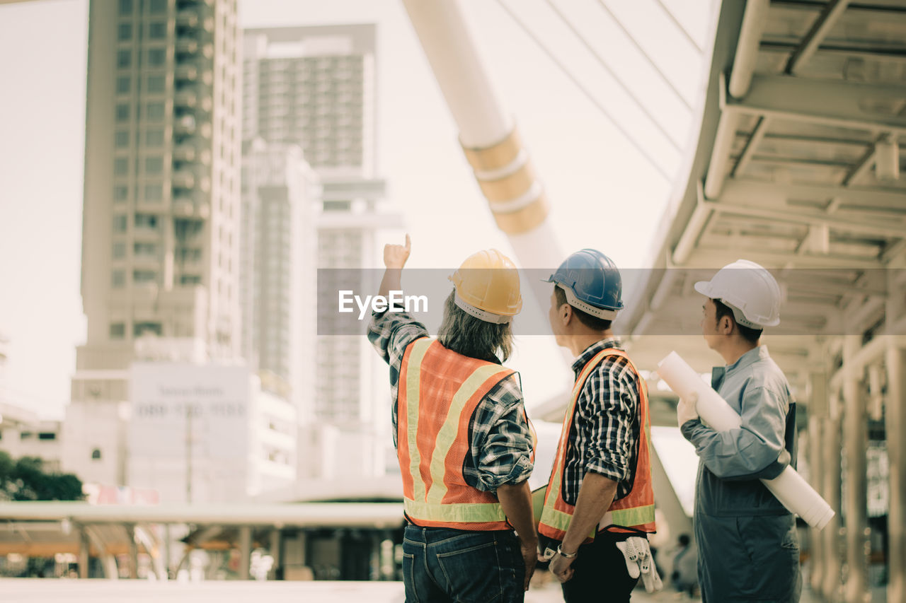 GROUP OF PEOPLE AT CONSTRUCTION SITE