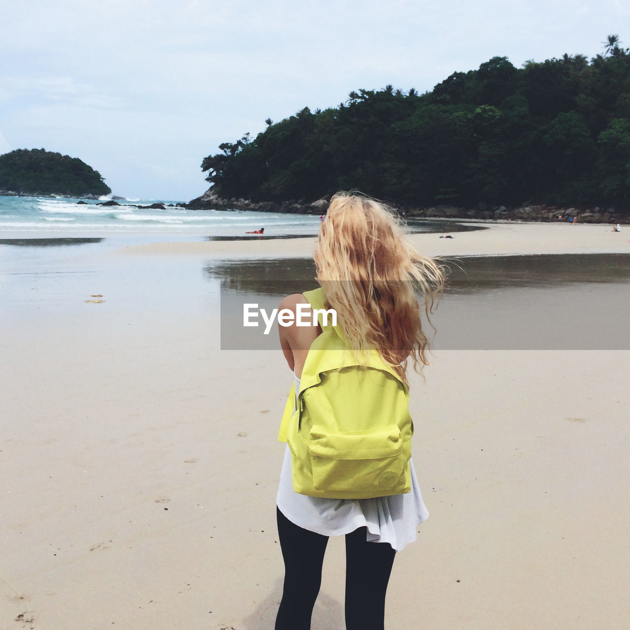 Rear view of woman standing on beach