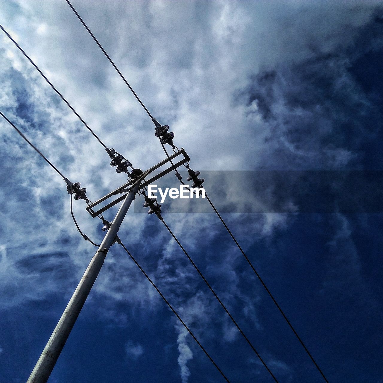 LOW ANGLE VIEW OF POWER CABLES AGAINST SKY