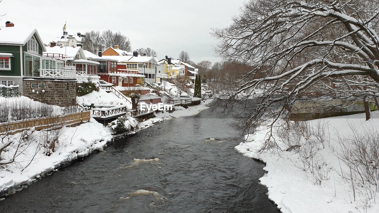 SNOW COVERED HOUSES BY CANAL AND BUILDINGS