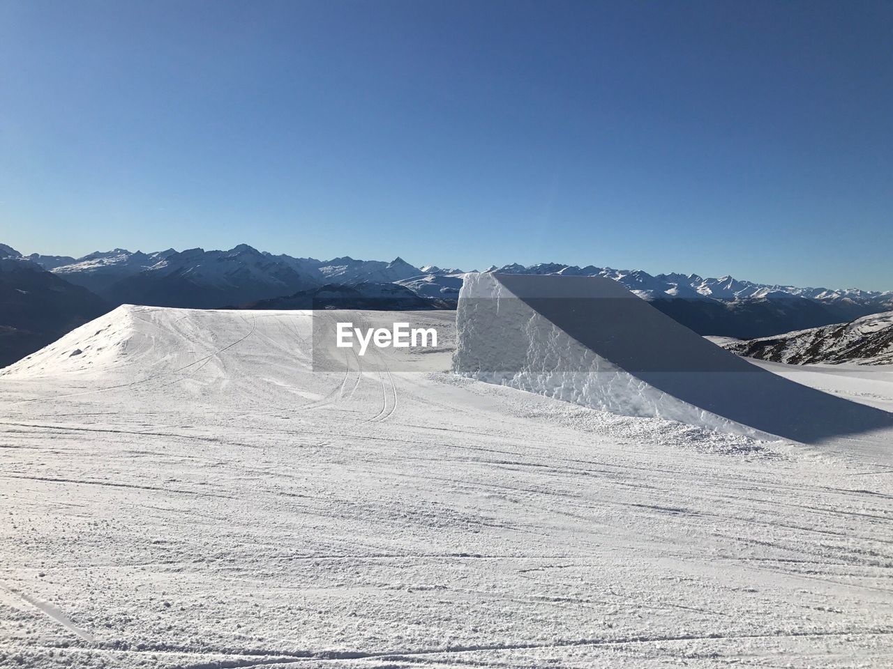 SNOWCAPPED MOUNTAINS AGAINST CLEAR BLUE SKY