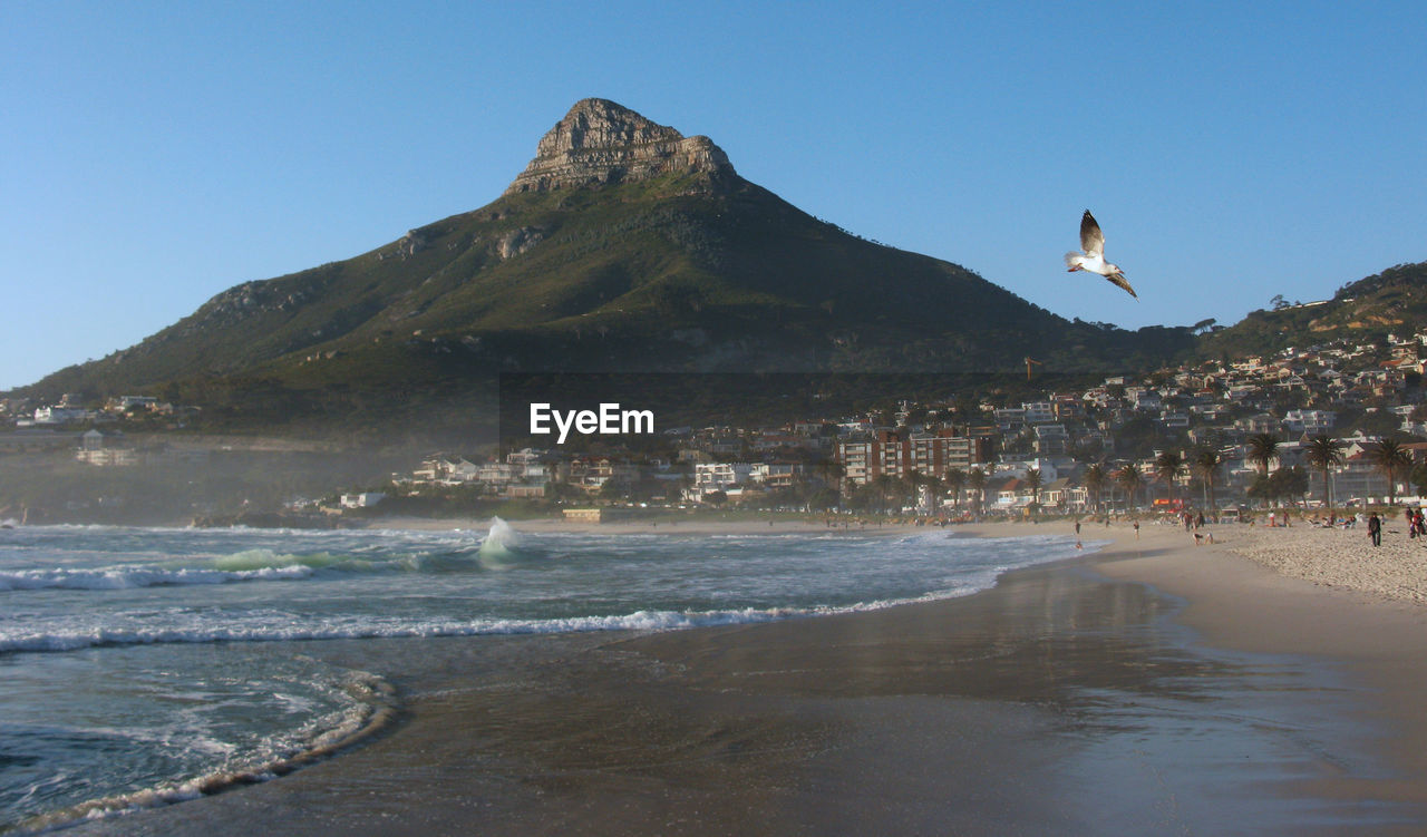 SCENIC VIEW OF SEA AND MOUNTAIN AGAINST SKY