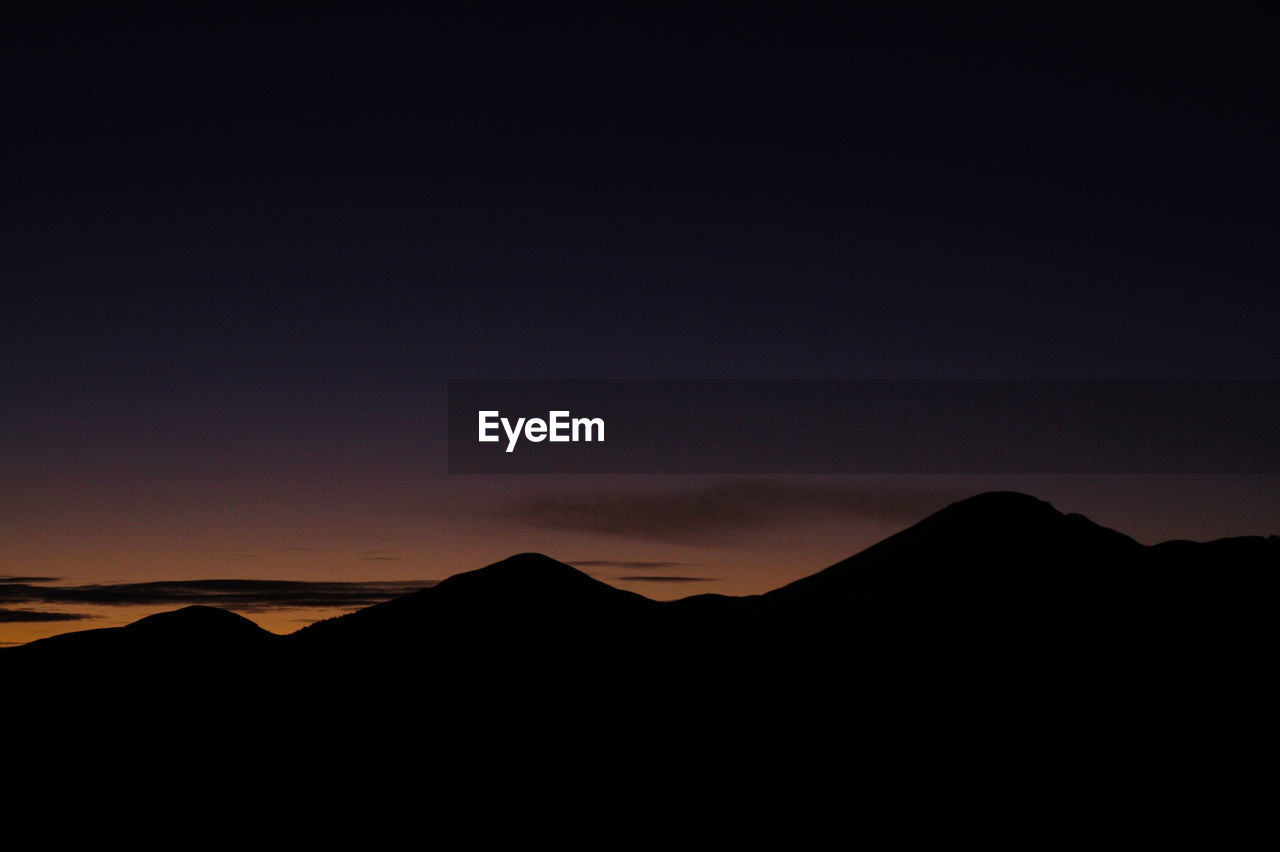 SCENIC VIEW OF SILHOUETTE MOUNTAINS AGAINST SKY