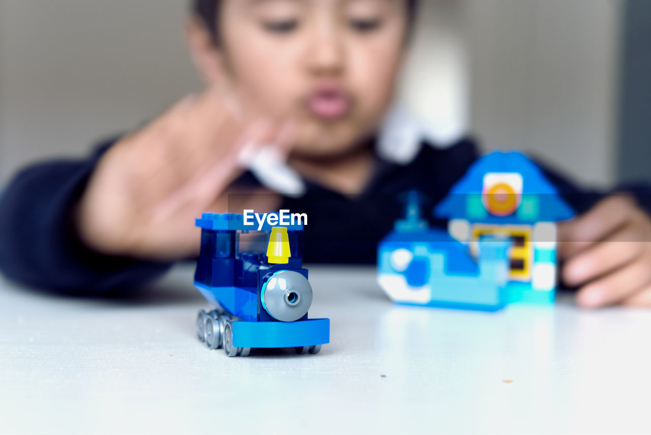 Boy playing with toys at table