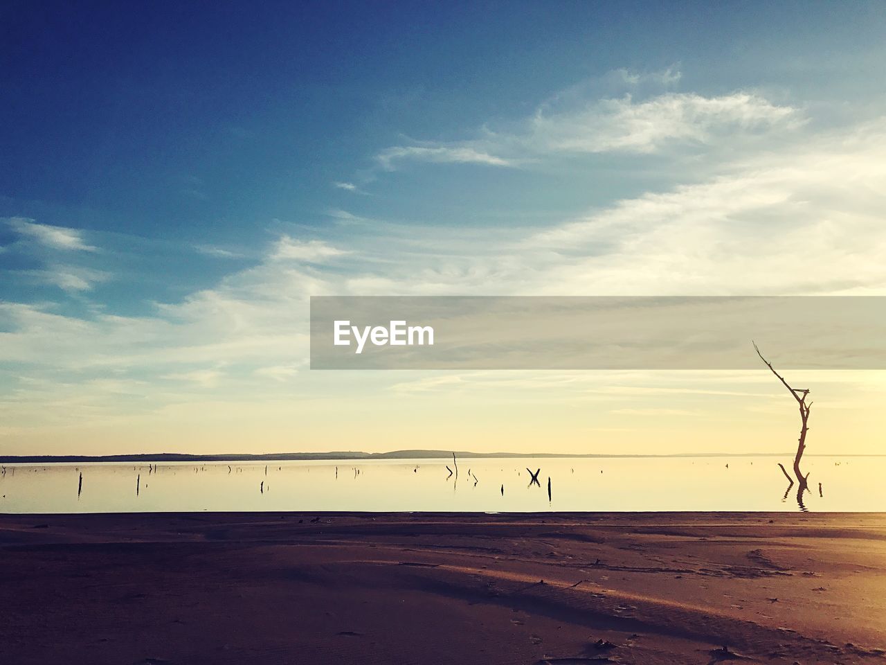 SCENIC VIEW OF BEACH DURING SUNSET