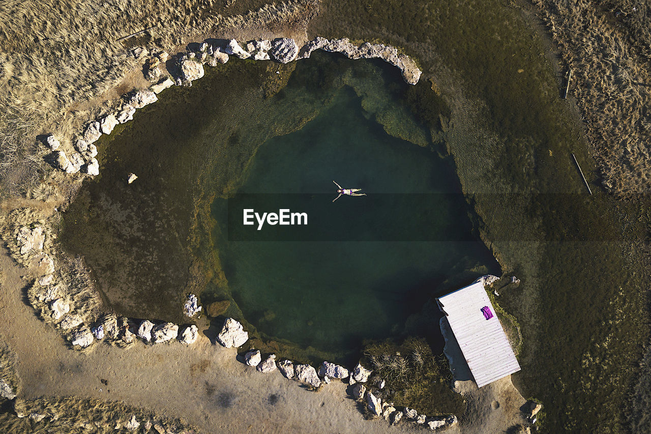 Aerial view of woman swimming in lake