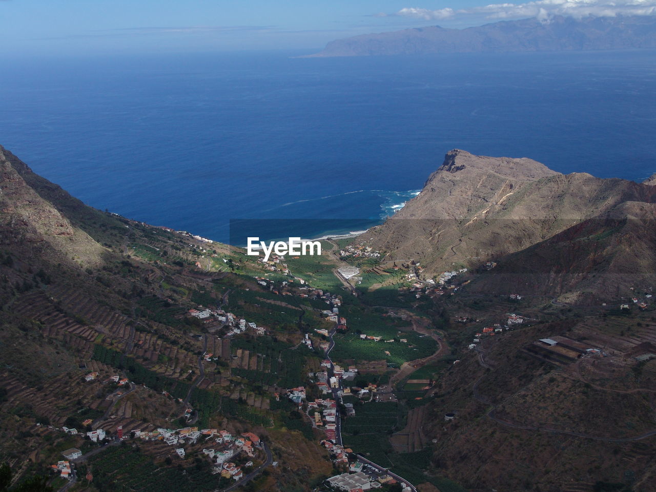 High angle view of city by sea against sky