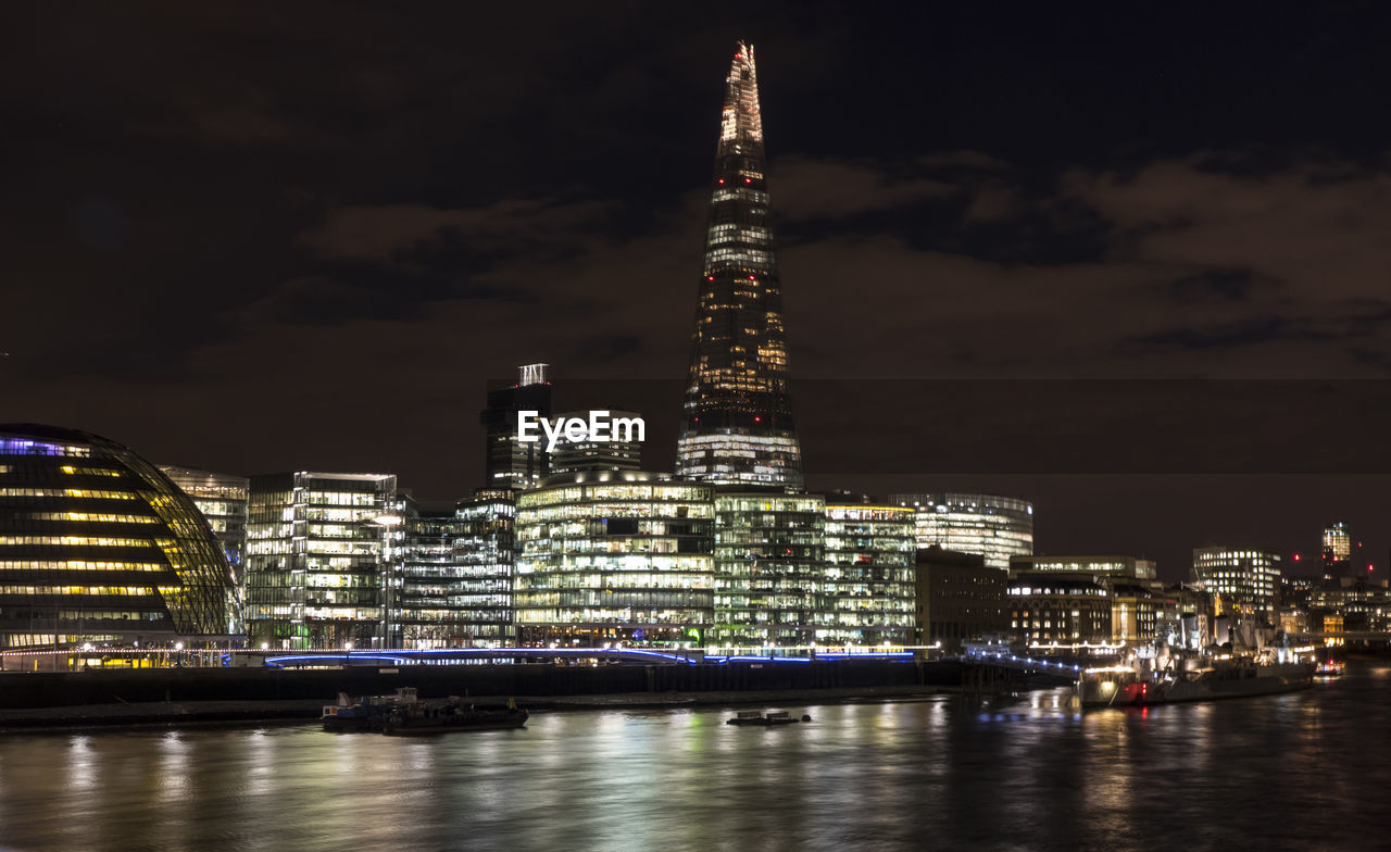The shard and the city hall in london at night with light