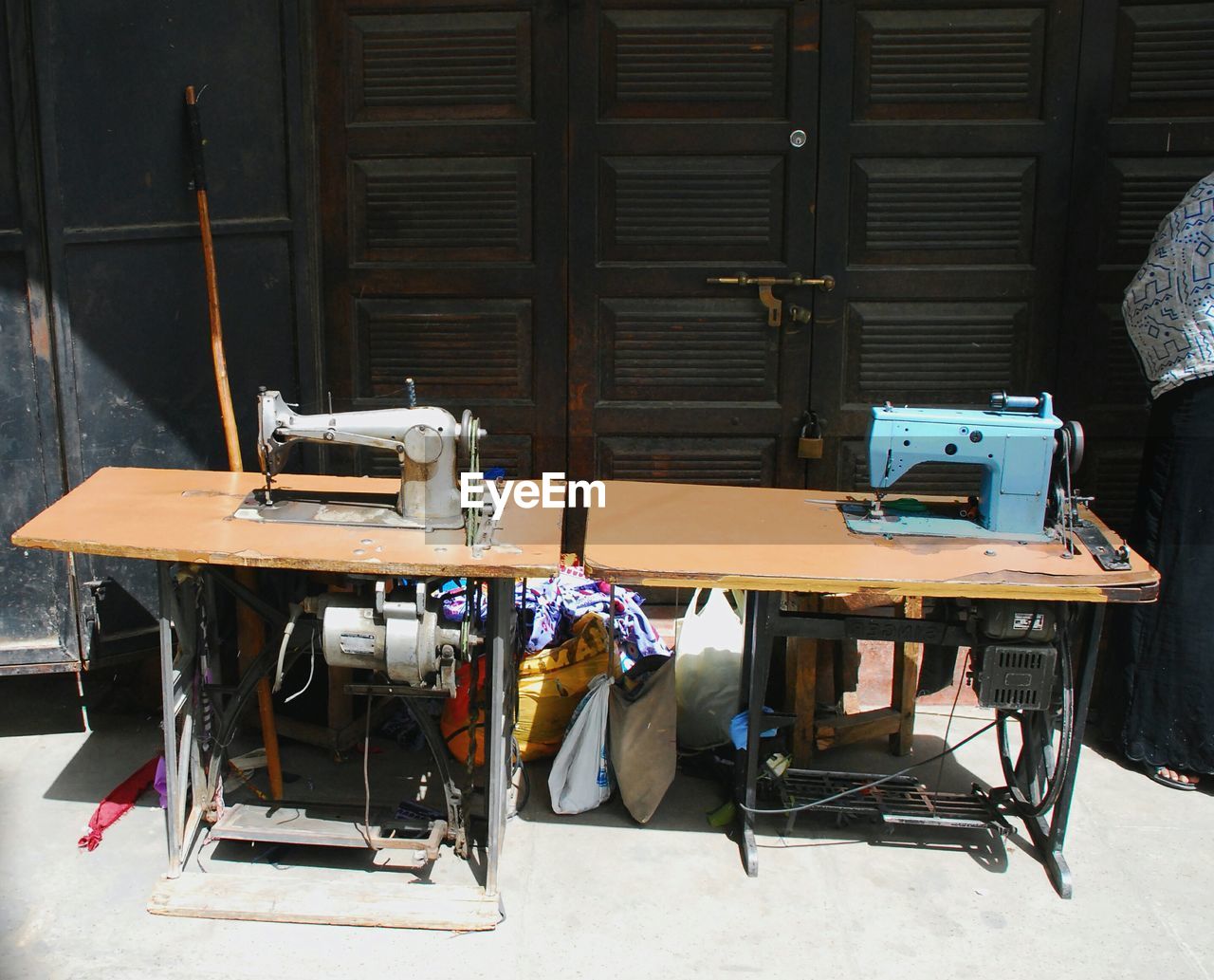 High angle view of sewing machines by closed wooden door