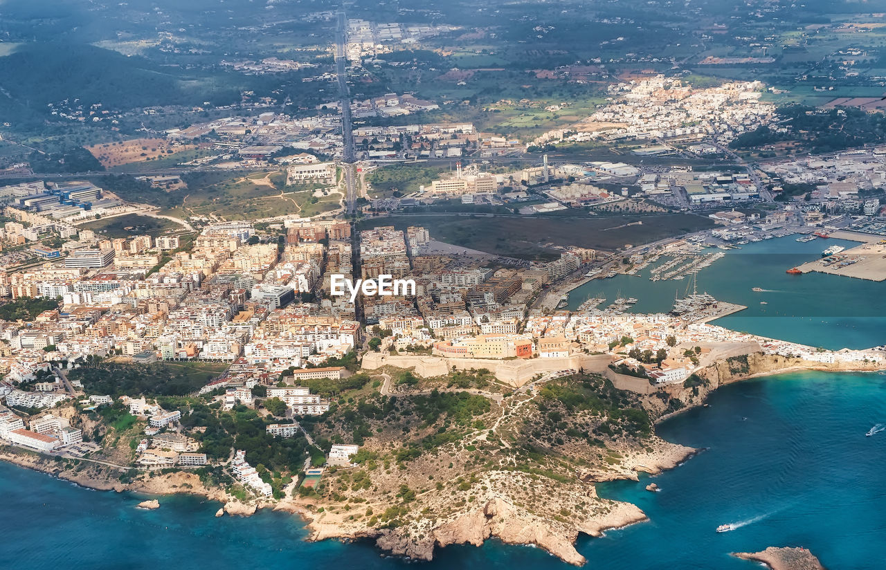 Aerial view of cityscape by sea