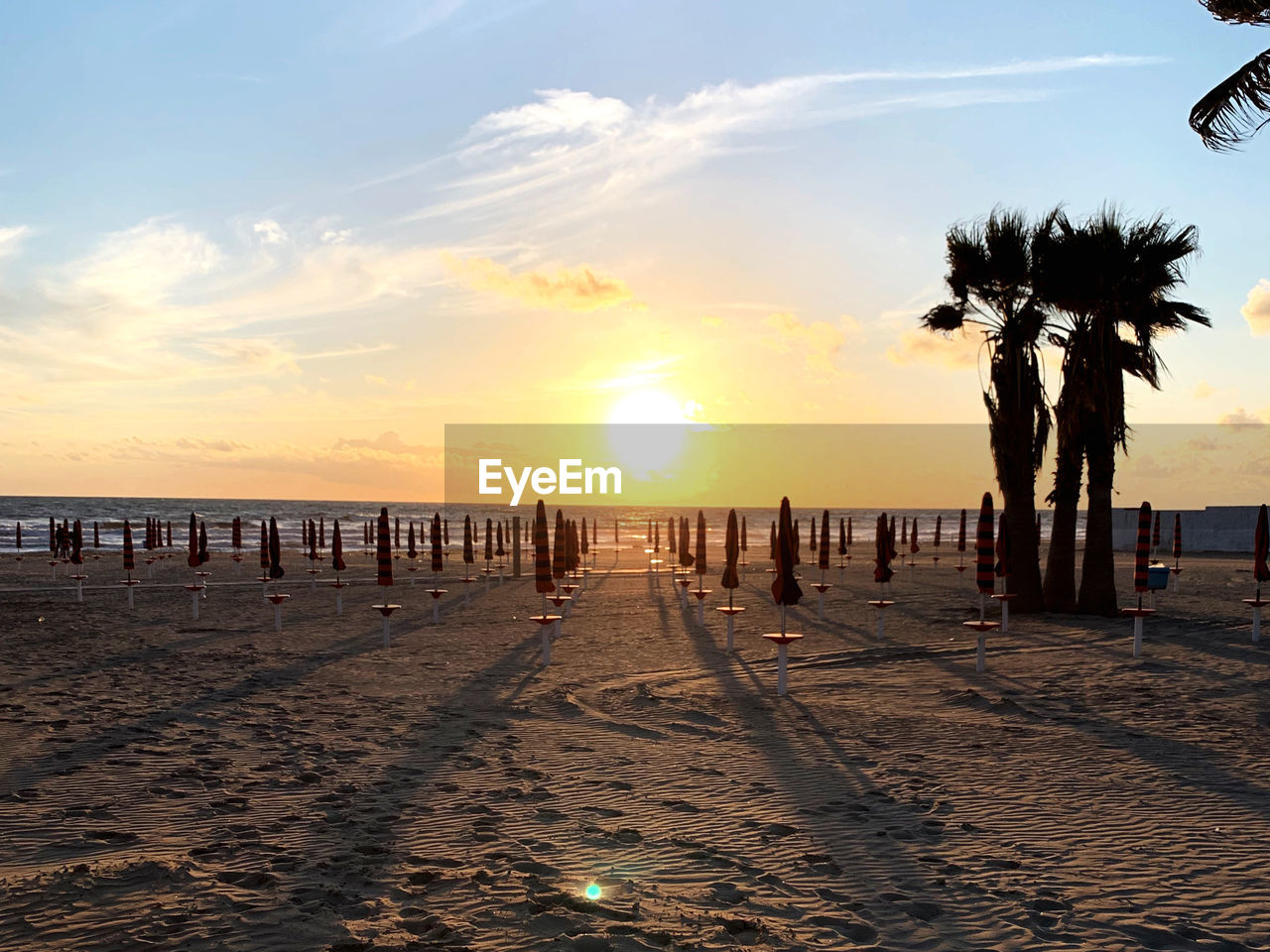 Scenic view of beach against sky during sunset