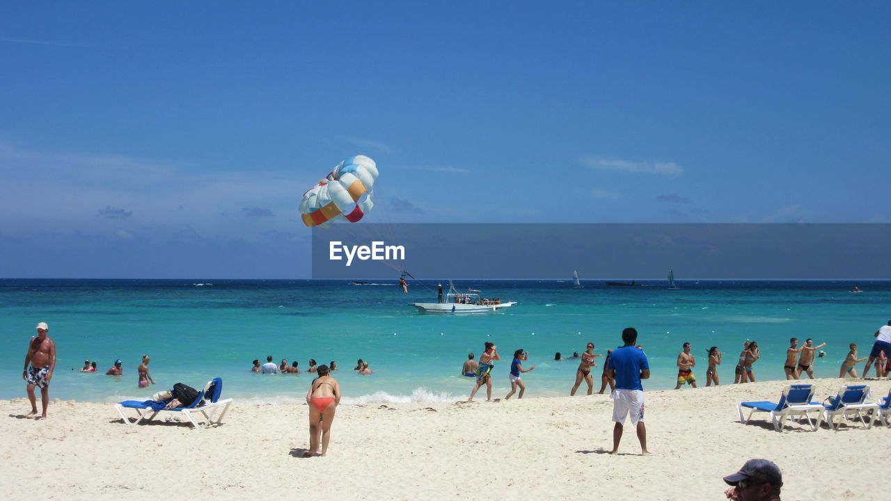 People enjoying summer at beach on sunny day