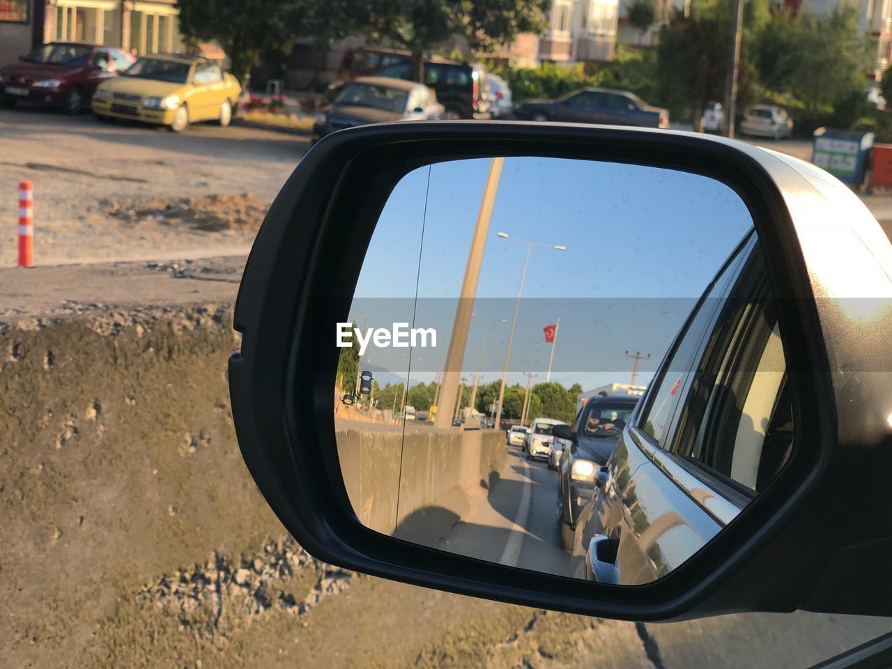 REFLECTION OF ROAD IN SIDE-VIEW MIRROR