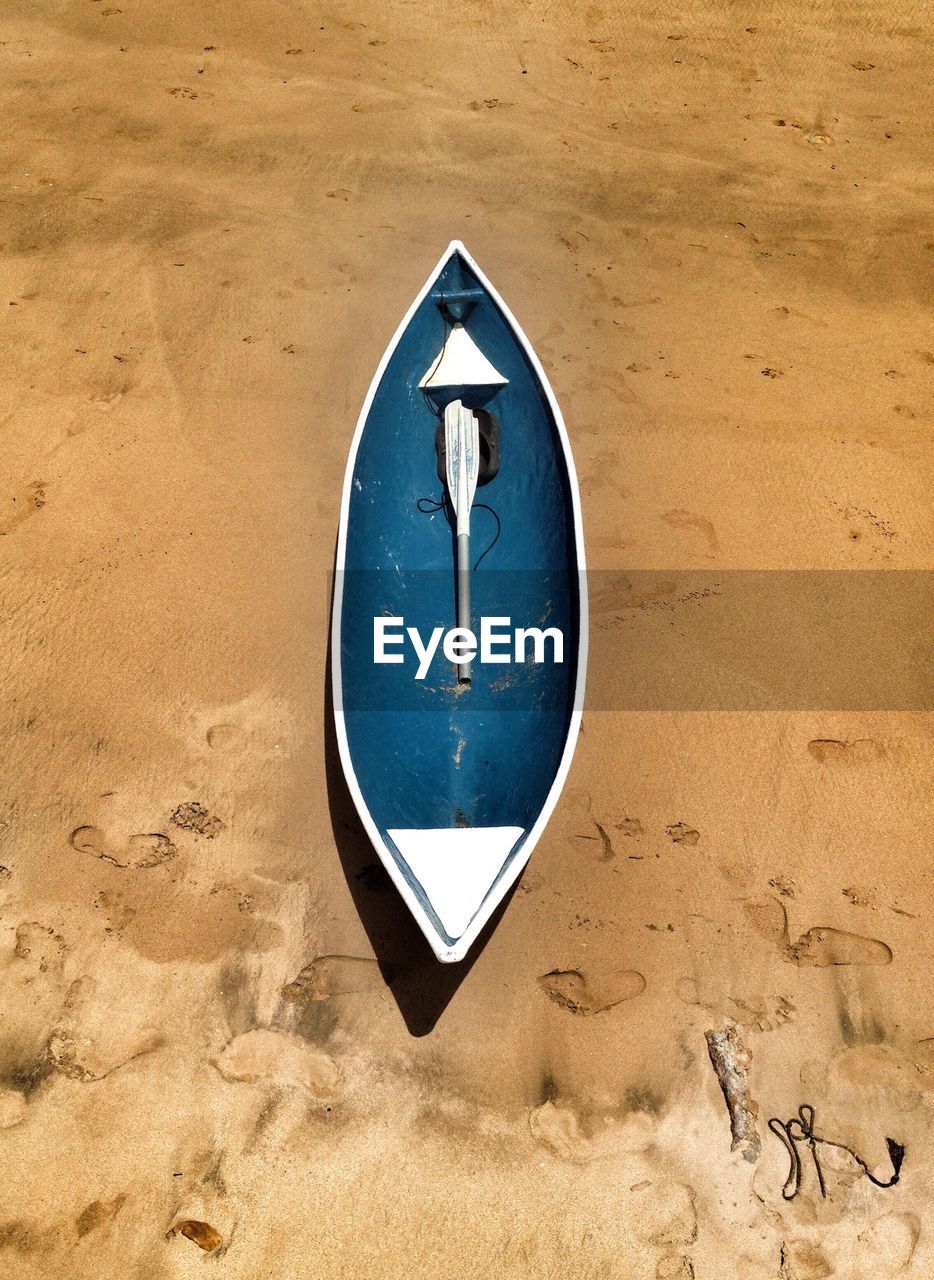 High angle view of empty boat moored on beach