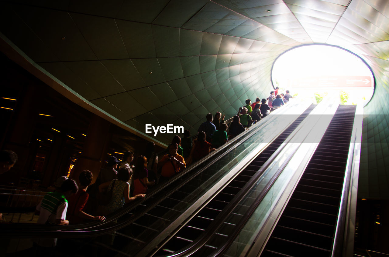 Low angle view of tourists on escalators at universal studio singapore