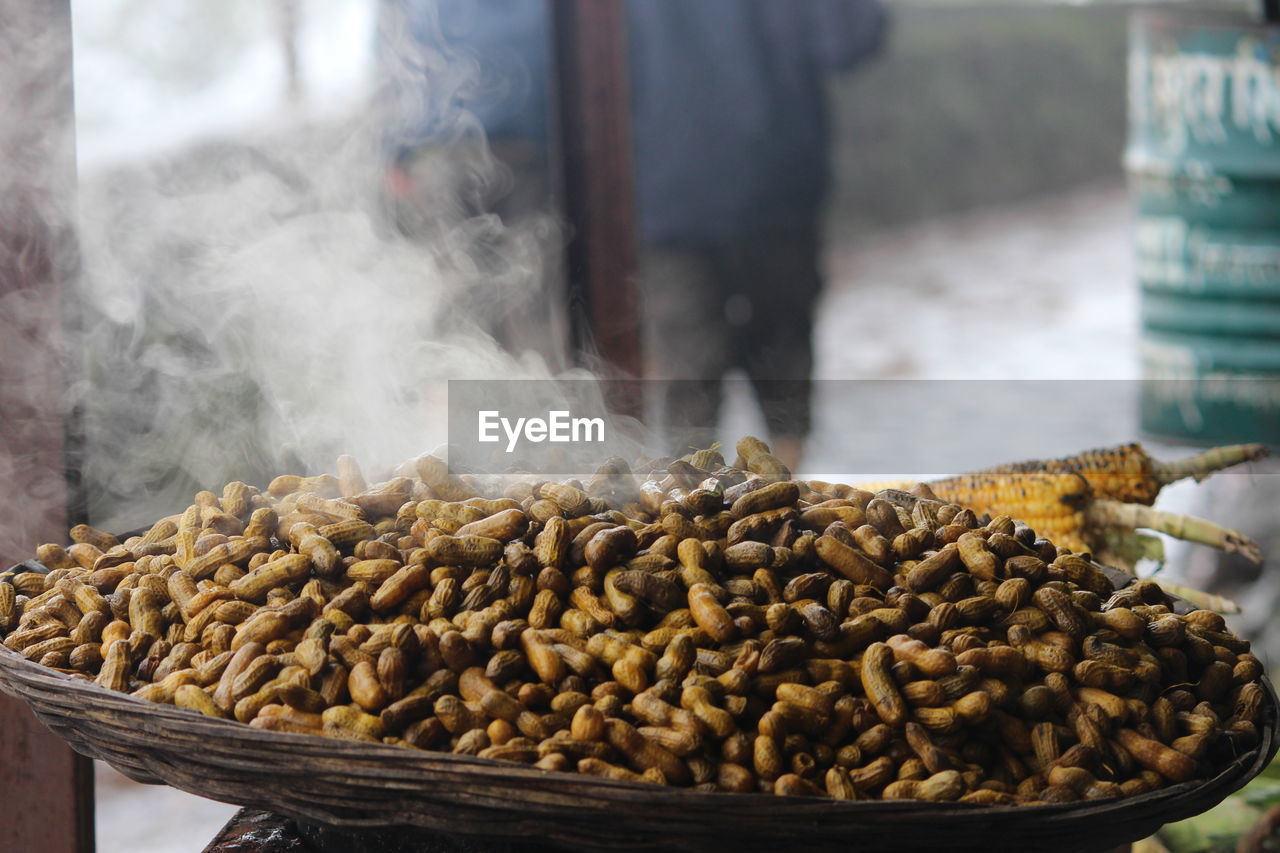 Close-up of peanuts in basket at market for sale