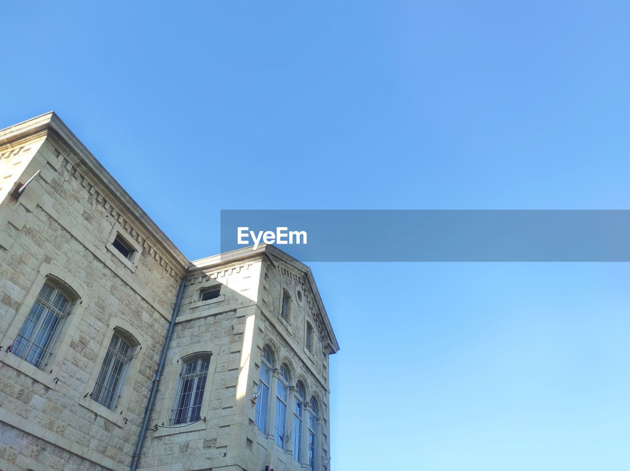 Low angle view of a xix century building against blue sky