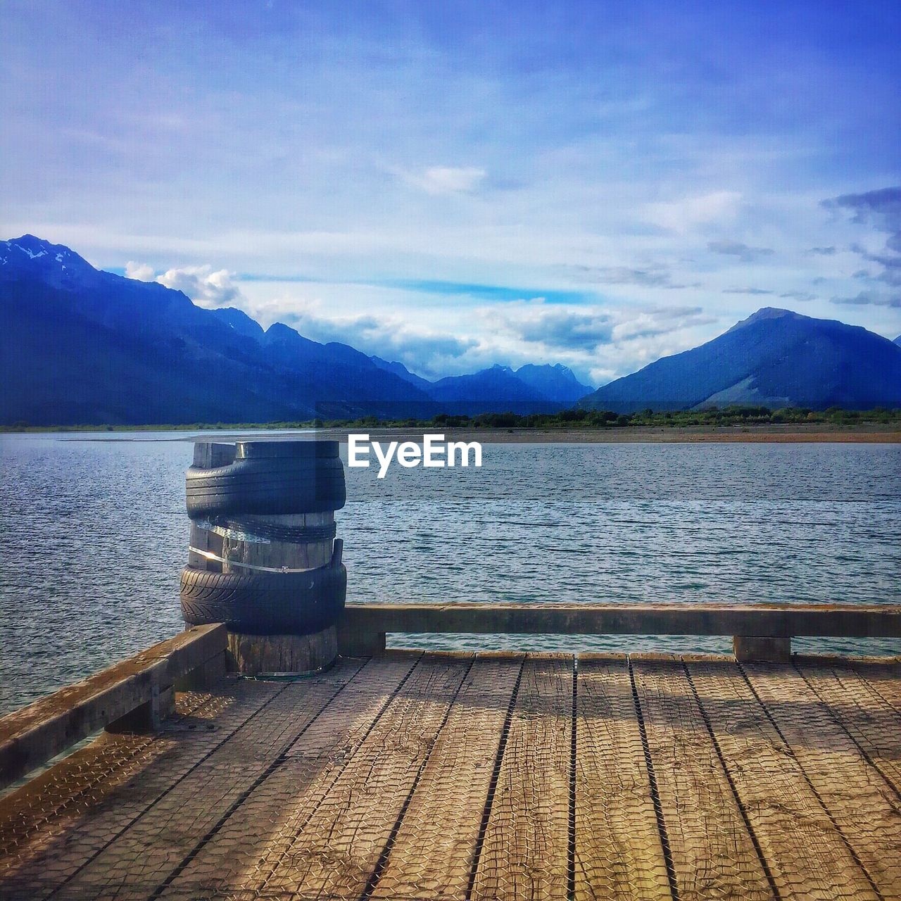 Cropped wooden jetty against calm blue sea