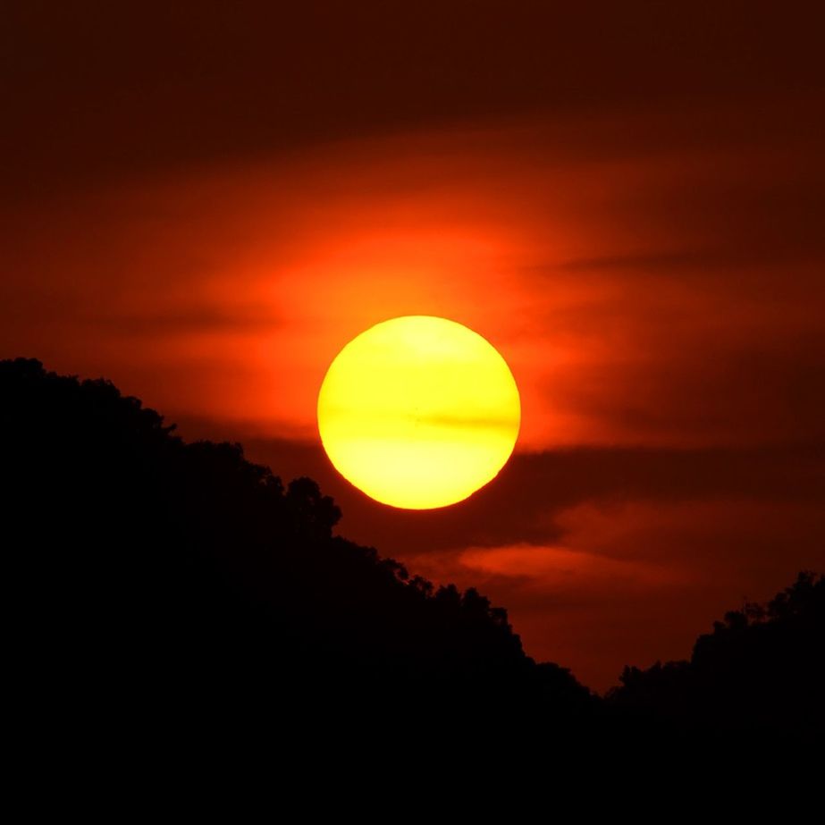 SUN SHINING THROUGH CLOUDS