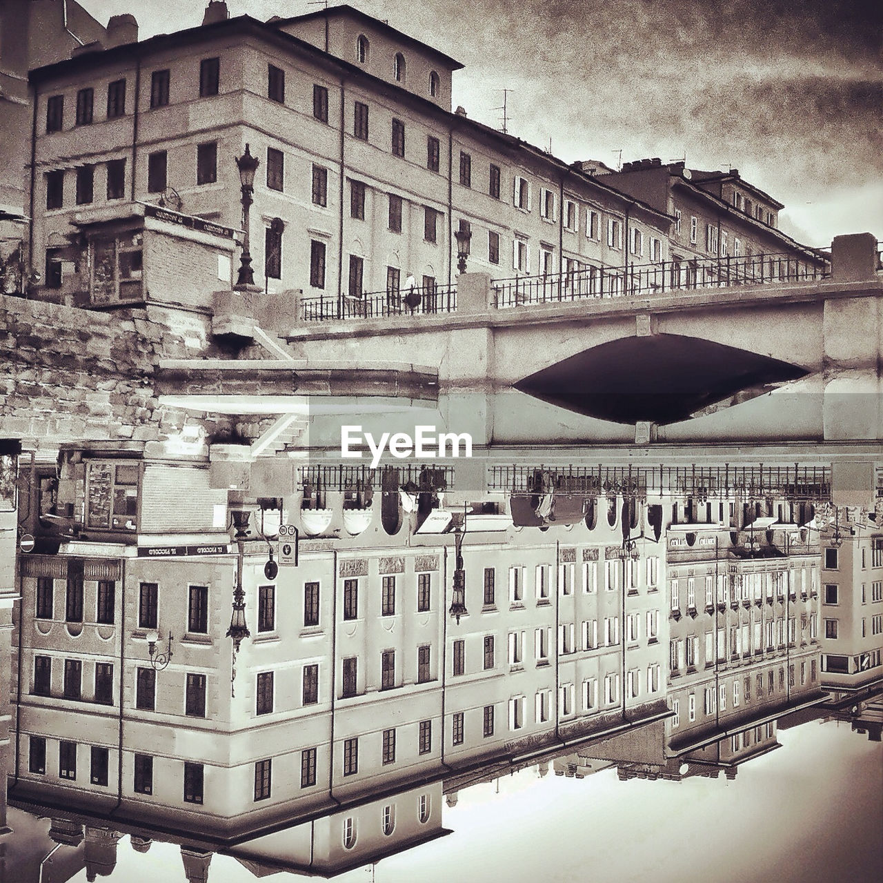 Mirror image of bridge and old building