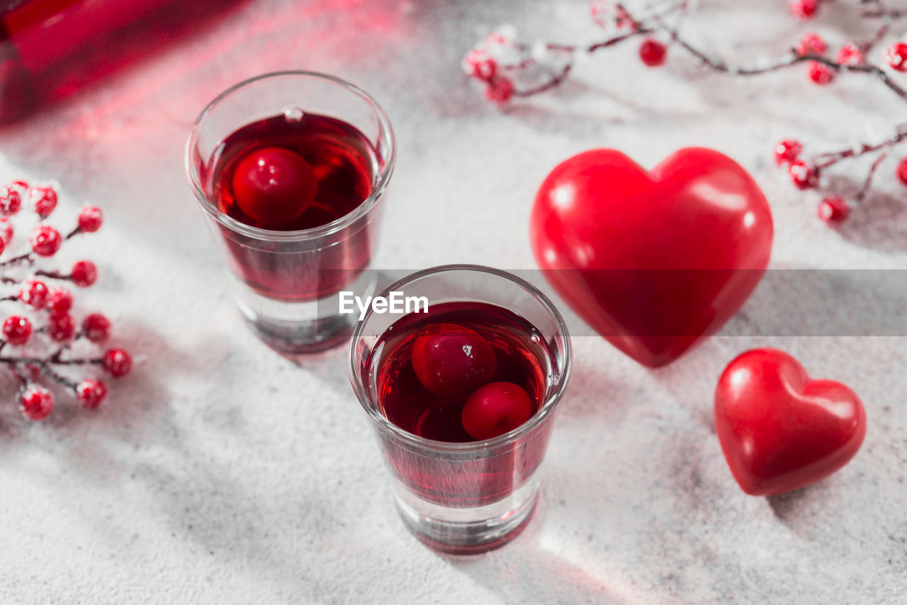 Red cocktail, vodka or liqueur and heart shape decorations