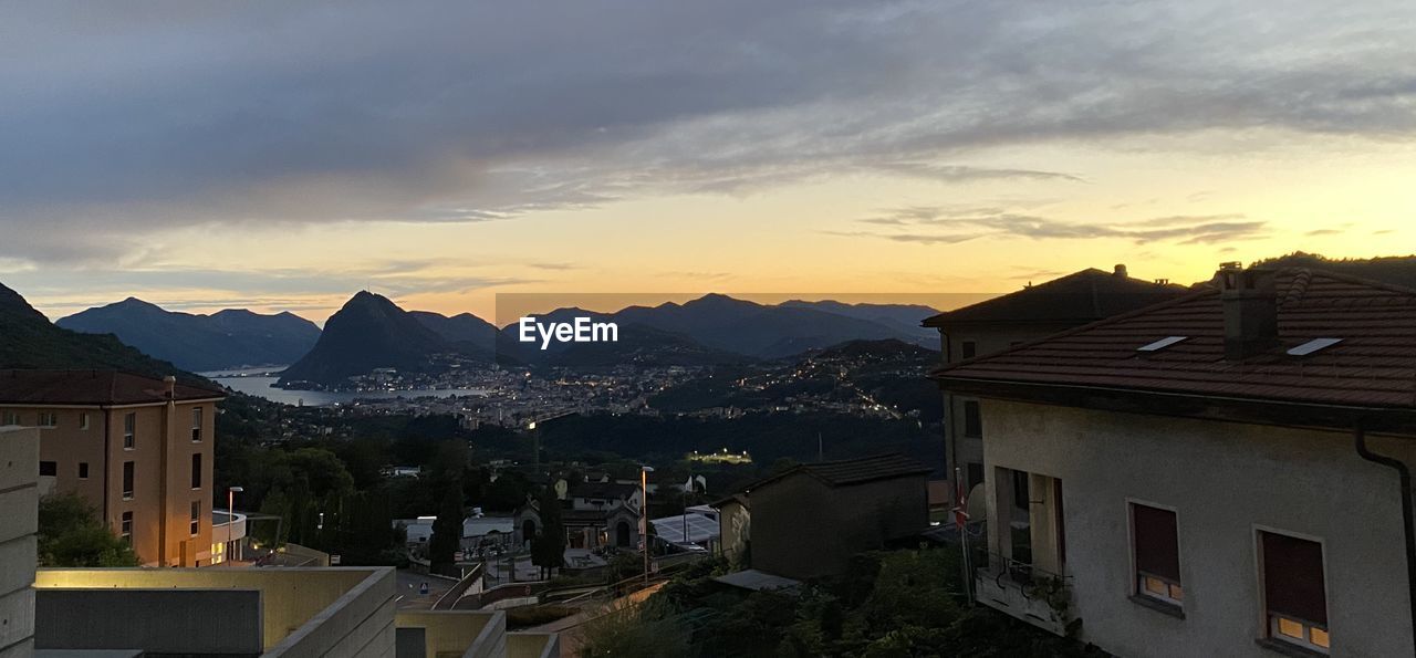 HIGH ANGLE VIEW OF BUILDINGS AGAINST SKY DURING SUNSET