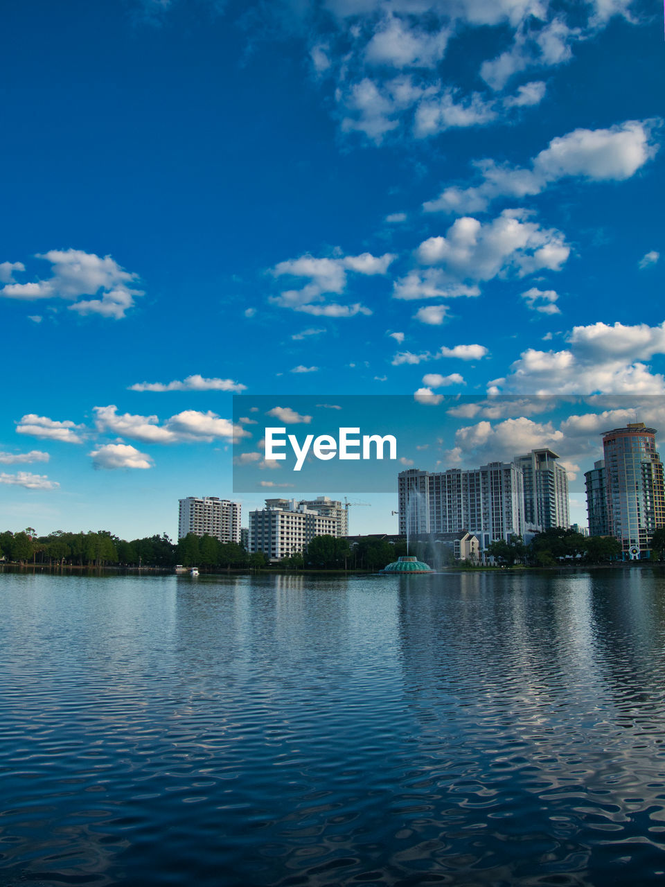 LAKE AND BUILDINGS AGAINST SKY