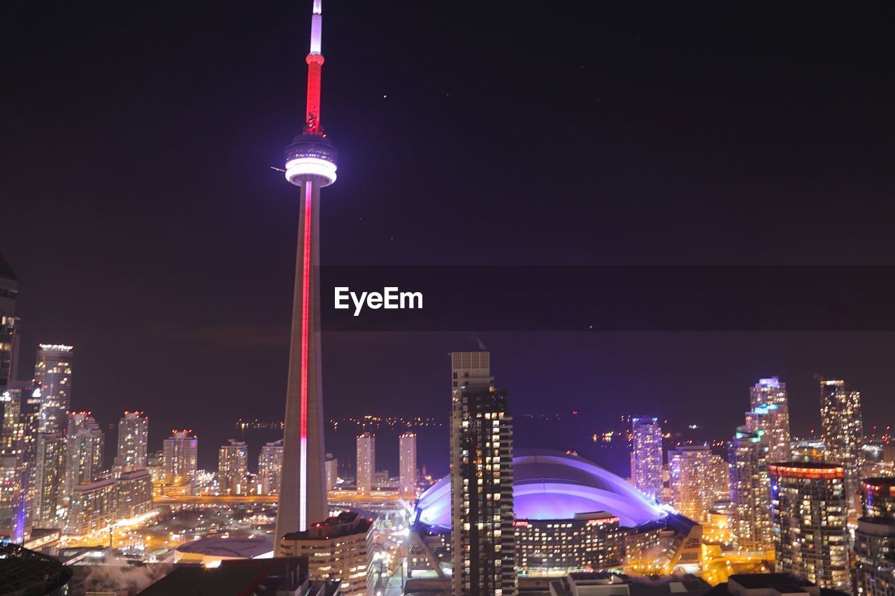 Illuminated buildings against clear sky