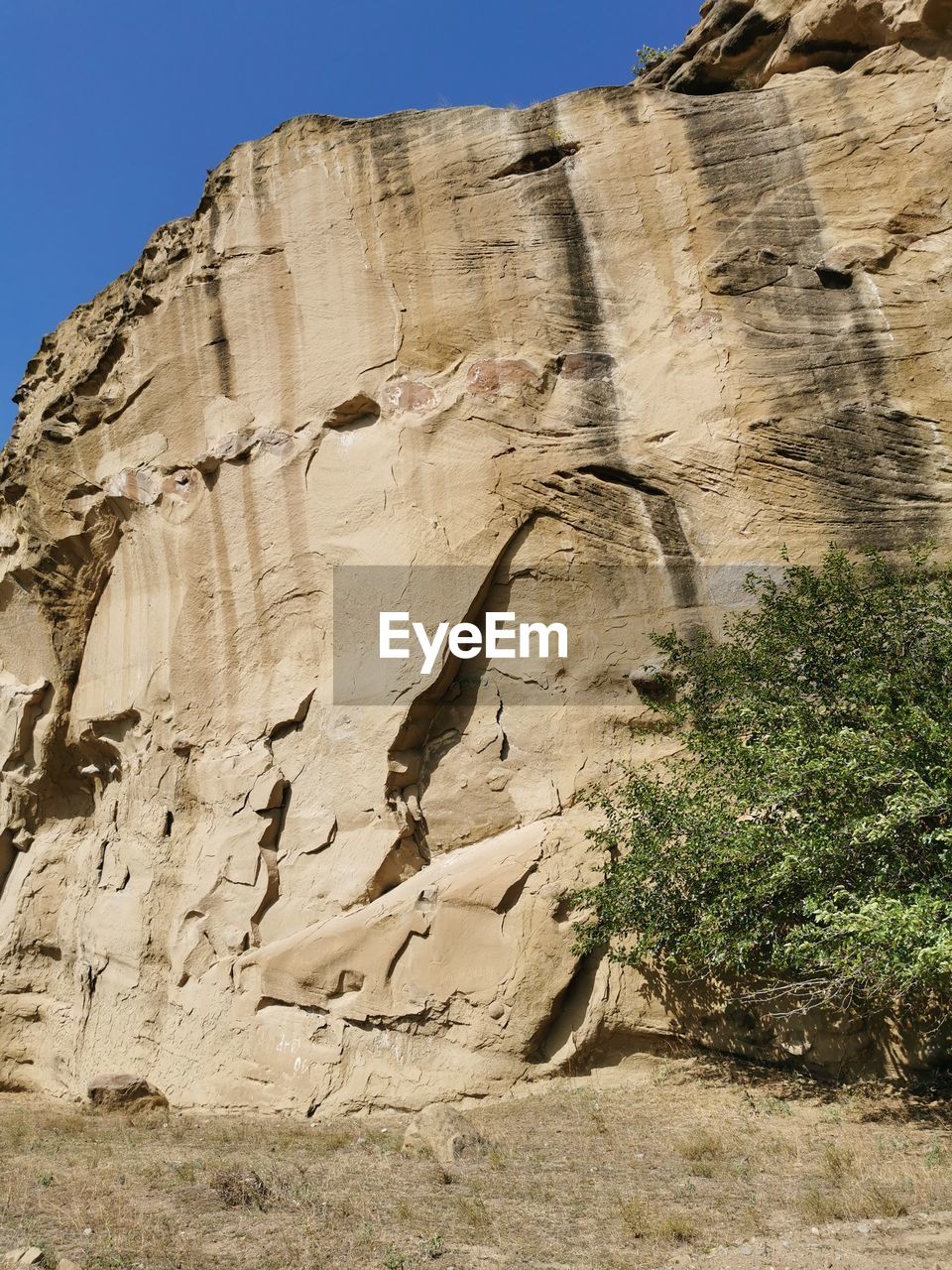 LOW ANGLE VIEW OF ROCK FORMATION ON LAND AGAINST SKY