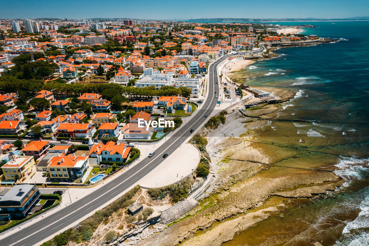 Aerial drone view of marginal avenue and coastline with parade district in greater lisbon, portugal 