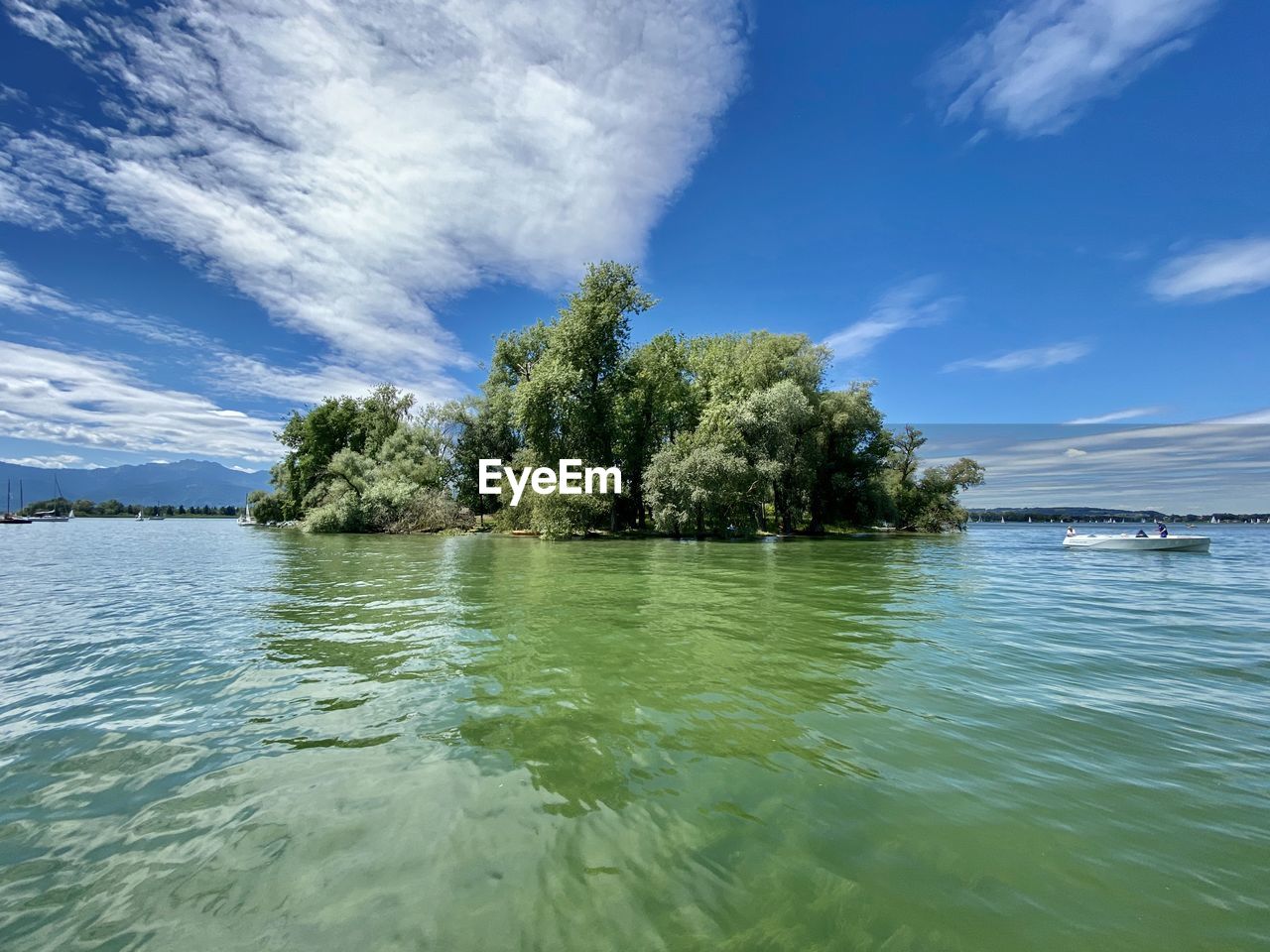 SCENIC VIEW OF SEA AND TREES AGAINST SKY