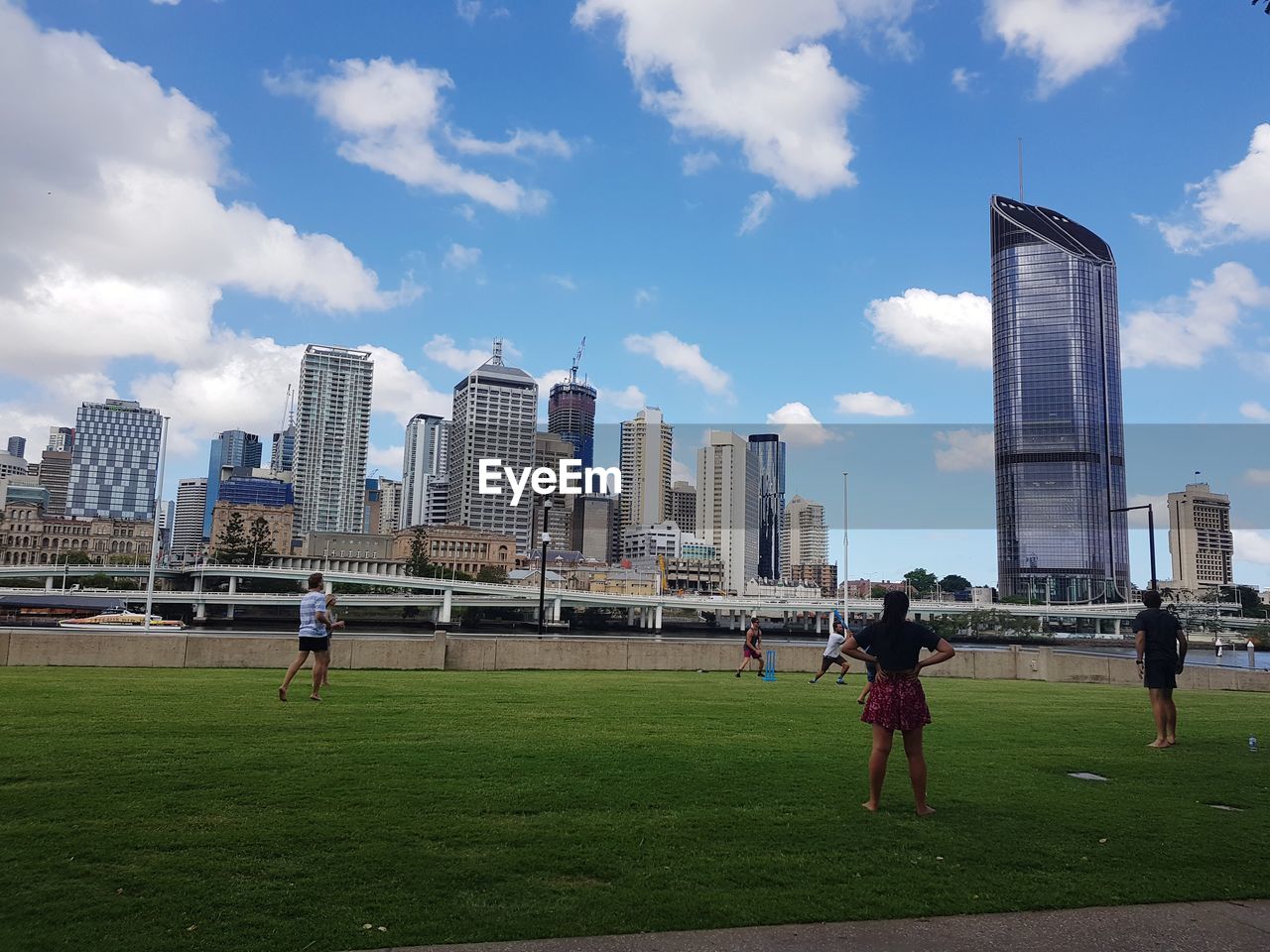 PEOPLE PLAYING SOCCER AGAINST SKY