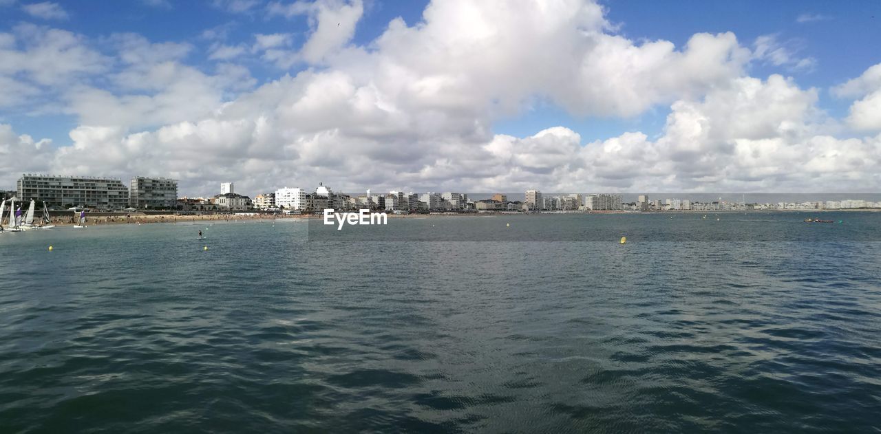 PANORAMIC VIEW OF SEA AGAINST BUILDINGS IN CITY