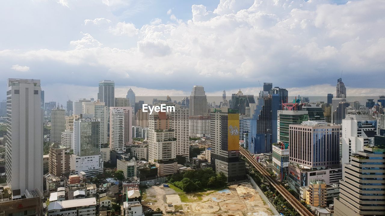 High angle view of modern buildings in city against sky
