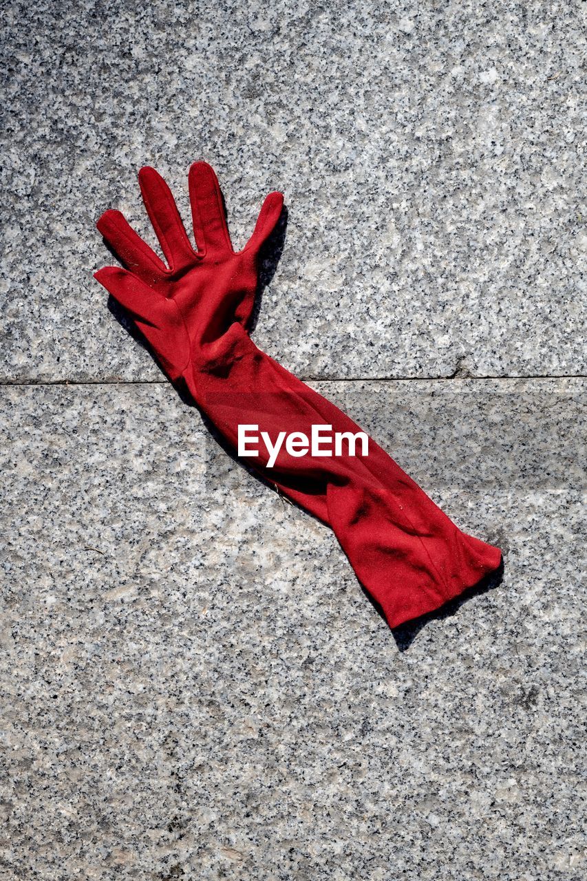 High angle view of red glove on tiled floor