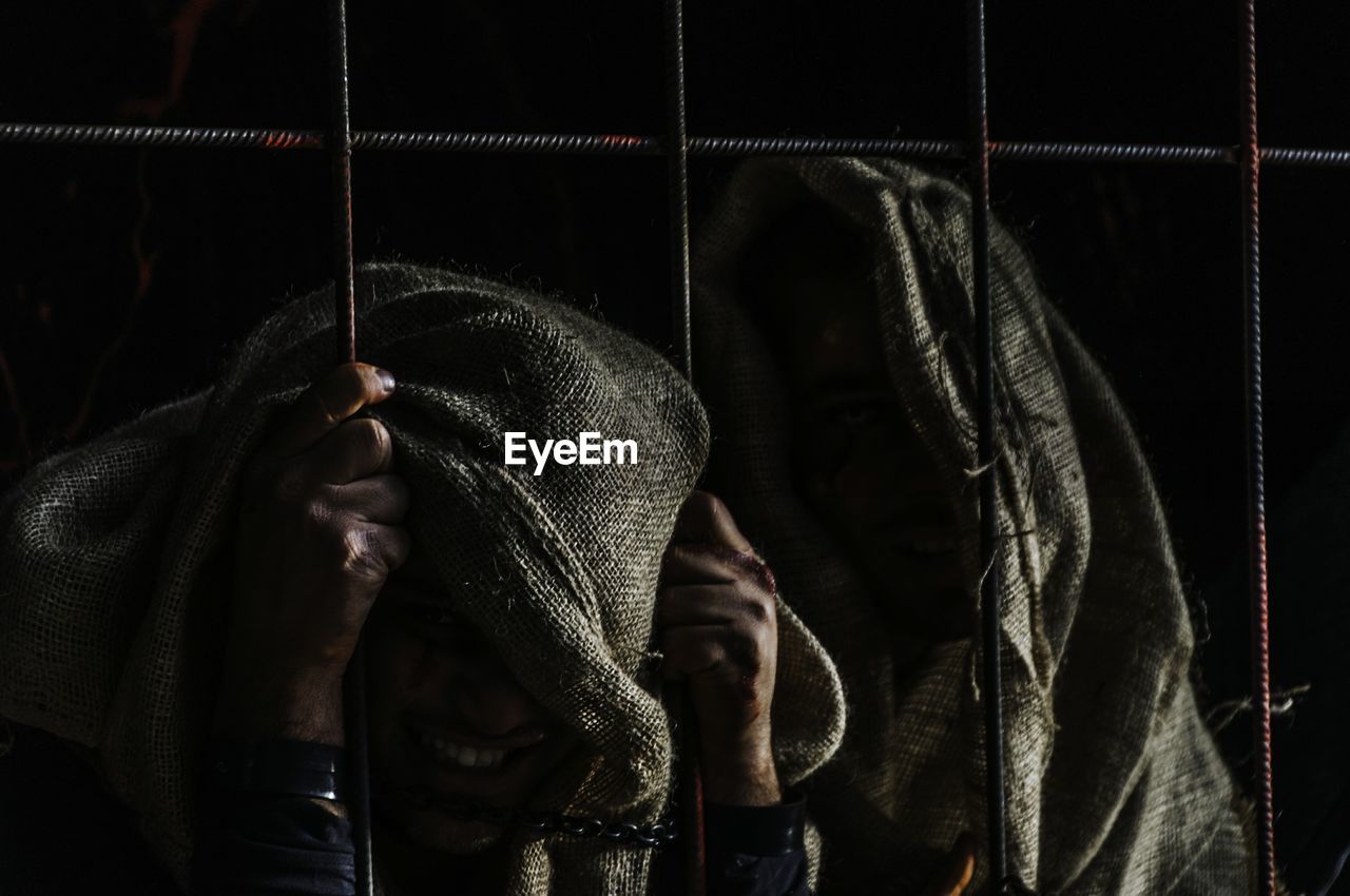 People with covered face in prison