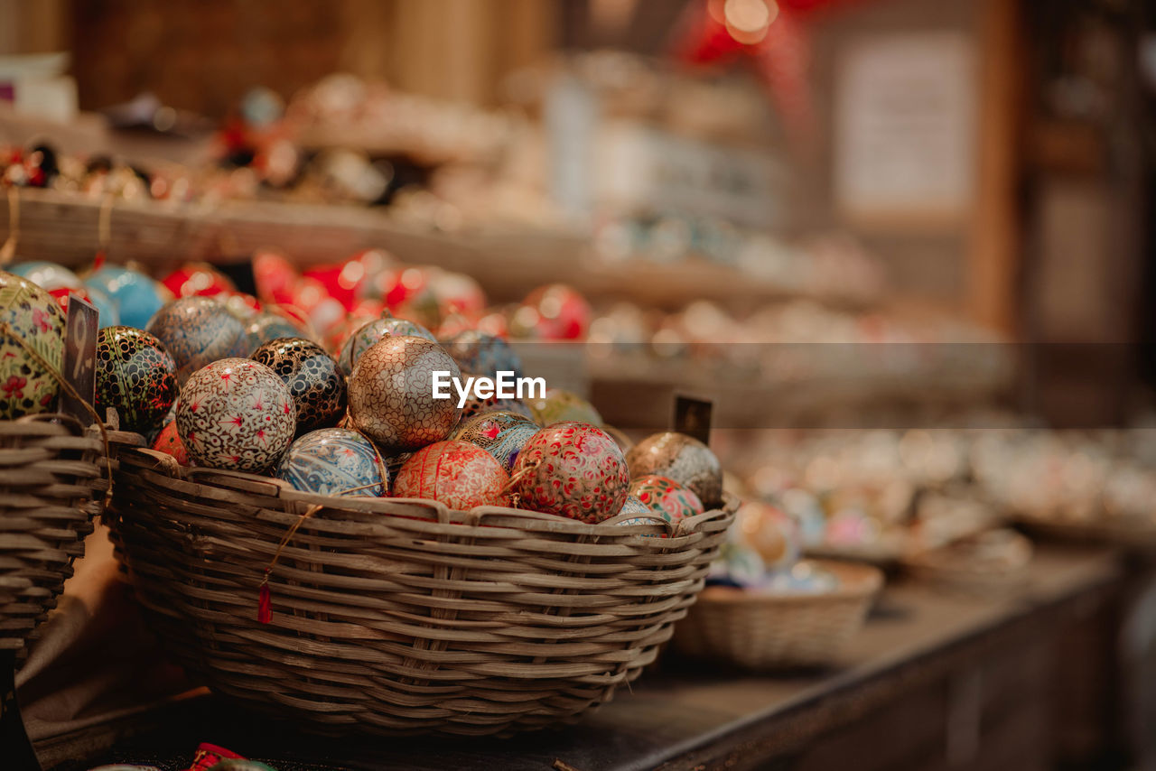 Close-up of colorful easter eggs in wicker baskets for sale in store