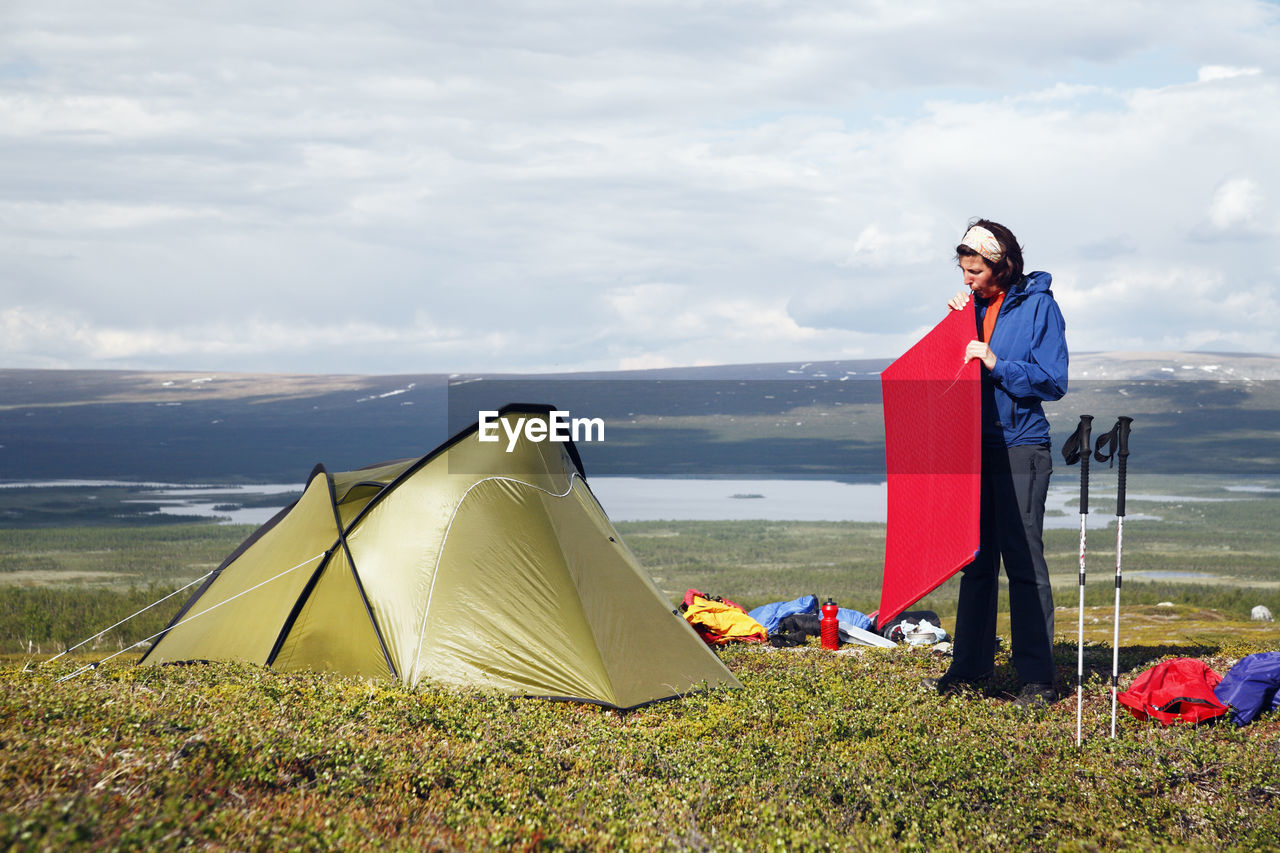 Woman near tent in mountains